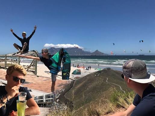Kiters on the water at Kite Beach with Table Mountain behind