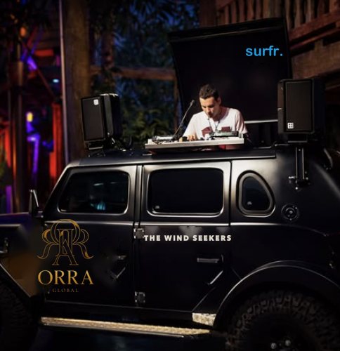 DJ on a black 4x4 branded ORRA and The Wind Seekers at night