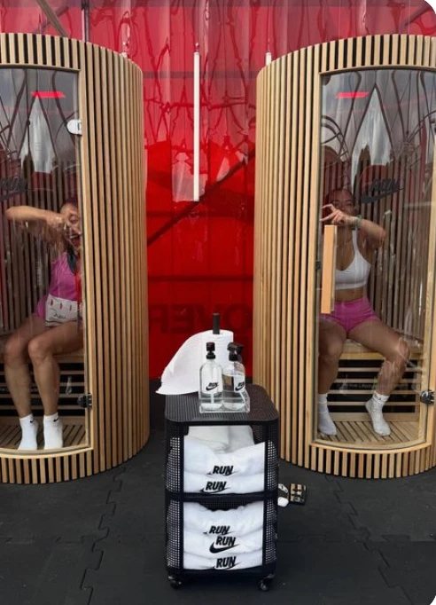 Two timber sauna pods with a towel trolley